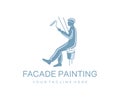 Builder, painter, climber paints the facade with roller and paint bucket, logo design. Industrial climber paint the wall of the bu