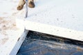 Builder placing polystyrene insulation boards on waterproofing membrane during floor construction. Royalty Free Stock Photo