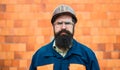 Builder. Portrait mechanical worker. Bearded man in suit with construction helmet. Portrait of handsome engineer