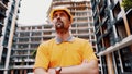 Builder portrait with proud expression. Successful constructor or architect with crossed arms. Construction worker standing with Royalty Free Stock Photo