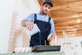 Builder pouring paint, primer in a paint tray Royalty Free Stock Photo