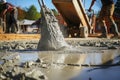 Builder pours ready mix concrete from a cement mixer truck at a construction site Royalty Free Stock Photo