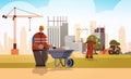 Builder pushing wheelbarrow with sand busy workman in protective uniform and helmet industrial worker building concept