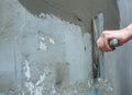 Builder puts mortar trowel wall. Plaster walls. Exterior finish