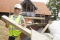 Builder Putting Waste Into Rubbish Skip Royalty Free Stock Photo