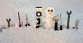 Builder repair tools. Little snowman with repairing instrument. Snow man worker. Royalty Free Stock Photo