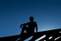 Builder resting on top of roof structure