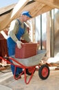 Builder roofer and wheel barrow Royalty Free Stock Photo