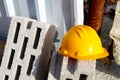 Builder`s helmet on expanded clay brick. Safety in Work, Building