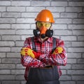Builder with safety equipment against brick wall background Royalty Free Stock Photo