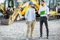 Builder with a sales consultant at the shop with heavy machinery Royalty Free Stock Photo