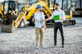 Builder with a sales consultant at the shop with heavy machinery Royalty Free Stock Photo