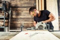 Builder saws a board Royalty Free Stock Photo