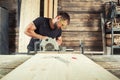 Builder saws a board Royalty Free Stock Photo