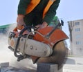 A builder saws a concrete brick with a circular saw. Royalty Free Stock Photo