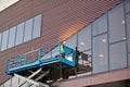 Builder on a Scissor Lift Platform at a construction site Royalty Free Stock Photo