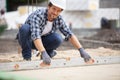 Builder screeding concrete on outdoor site Royalty Free Stock Photo