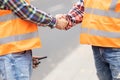 Builder shaking hand on the road construction field Royalty Free Stock Photo