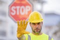 Builder showing STOP. Serious builder with stop road sign. Builder with stop gesture, no hand, dangerous on building