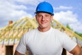 Builder on site in hardhat, smiling