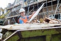 Builder On Site Putting Waste Into Rubbish Skip Royalty Free Stock Photo