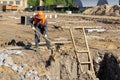 Builder sizzles the sand with a shovel in the pit Royalty Free Stock Photo