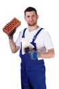 Builder standing with brick and spatula