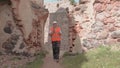 Builder surveyed the ruins of an old castle