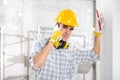 Builder talking on his mobile phone on site Royalty Free Stock Photo