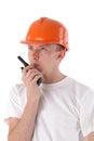 Builder talking on portable UHF radio transceiver Royalty Free Stock Photo