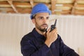 Builder talking on portable uhf radio transceiver Royalty Free Stock Photo