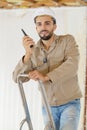 Builder talking on portable uhf radio transceiver Royalty Free Stock Photo