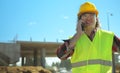 Builder talking by smartphone