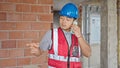 builder talking on smartphone at construction site