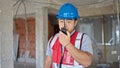 builder talking on walkie talkie at construction site Royalty Free Stock Photo