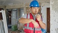 builder talking on walkie talkie at construction site Royalty Free Stock Photo