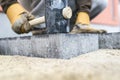 Builder tamping down a new paving slab or brick Royalty Free Stock Photo