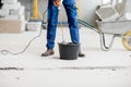 Builder mixing plaster at the construction site Royalty Free Stock Photo