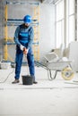 Builder mixing plaster at the construction site