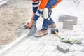 A builder uses a grinder and a diamond cutting disc to cut paving slabs in a cloud of cement dust Royalty Free Stock Photo