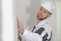 builder using sandpaper on interior wall Royalty Free Stock Photo