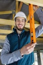 builder using spirit level to check roof joist Royalty Free Stock Photo