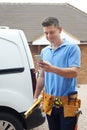 Builder With Van Checking Text Messages On Mobile Phone Outside Royalty Free Stock Photo