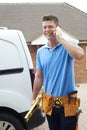 Builder With Van Talking On Mobile Phone Outside House Royalty Free Stock Photo