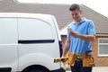 Builder With Van Texting On Mobile Phone Outside House Royalty Free Stock Photo