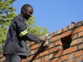 Builder at work polishing bricks.