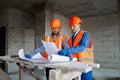 Builder worker with blueprint in indoor apartment Royalty Free Stock Photo