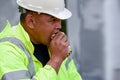 Builder worker eats at construction site Royalty Free Stock Photo
