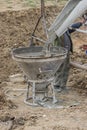 Builder worker filling concrete funnel