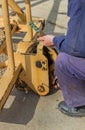 Builder worker greasing parts of the crane Royalty Free Stock Photo